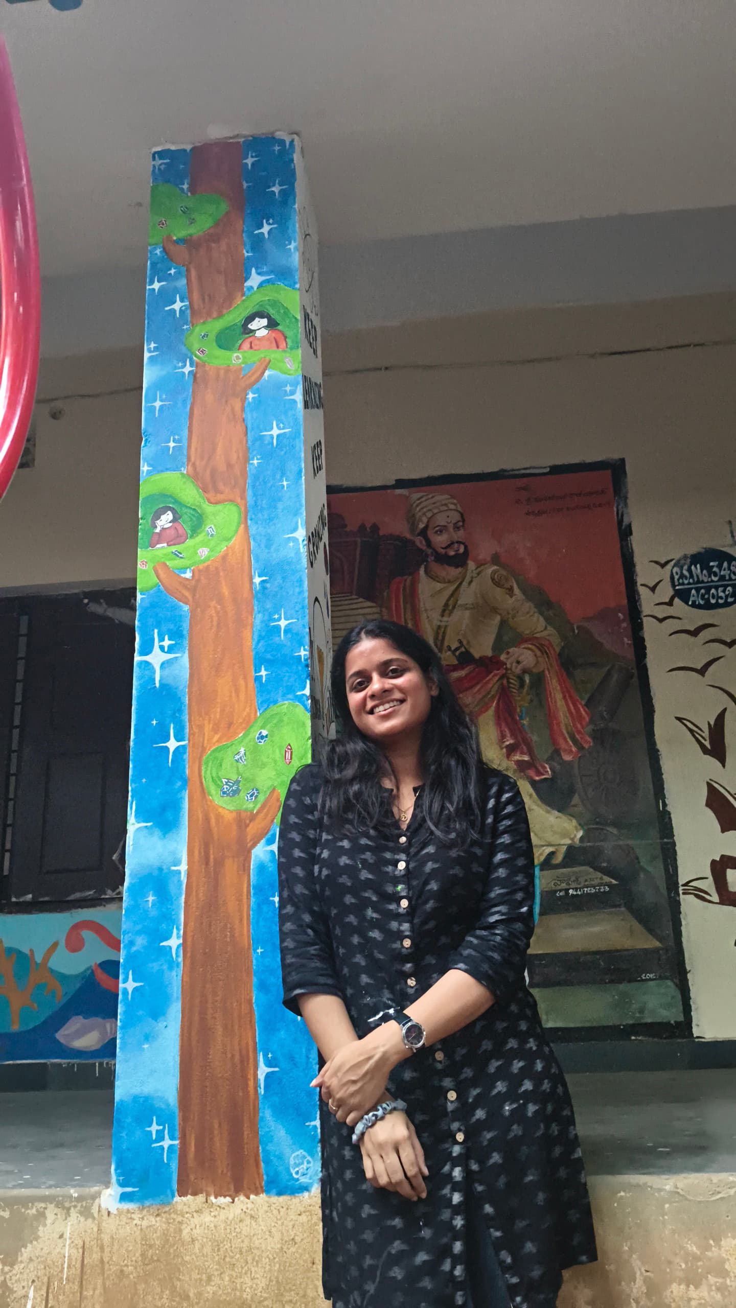 Painting a government school building as part of a group.